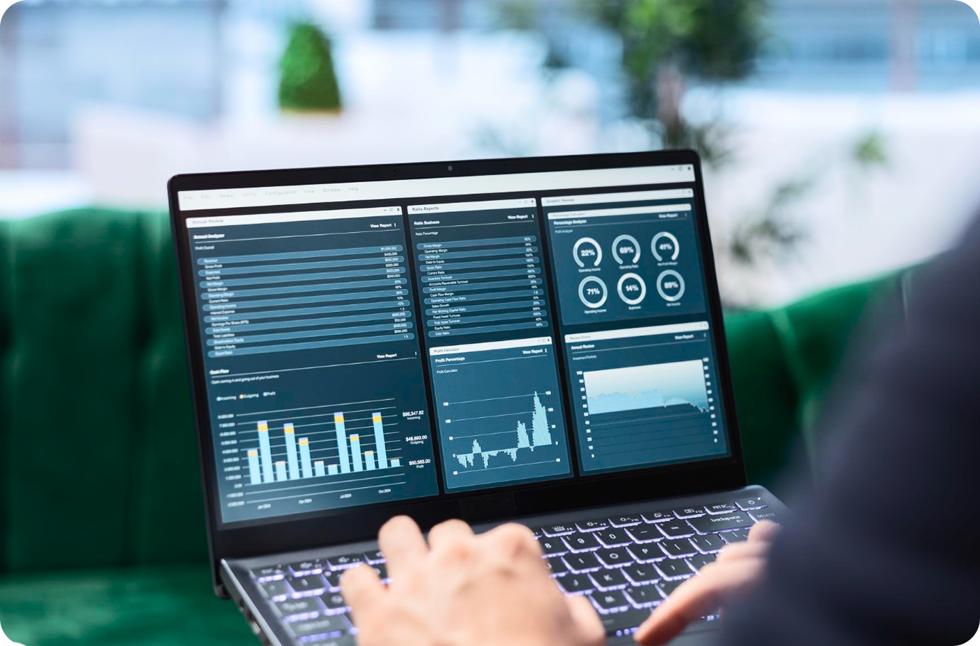 Person analyzing data on laptop with dashboards